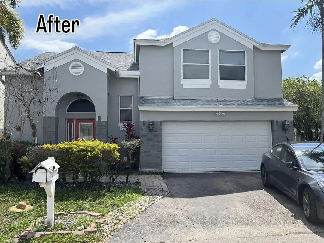 Two-story South Florida home after exterior painting in gray with white trim