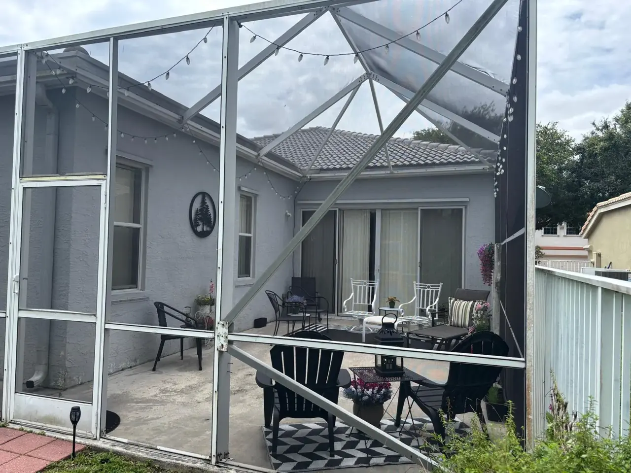 Screen-enclosed patio with freshly painted exterior walls