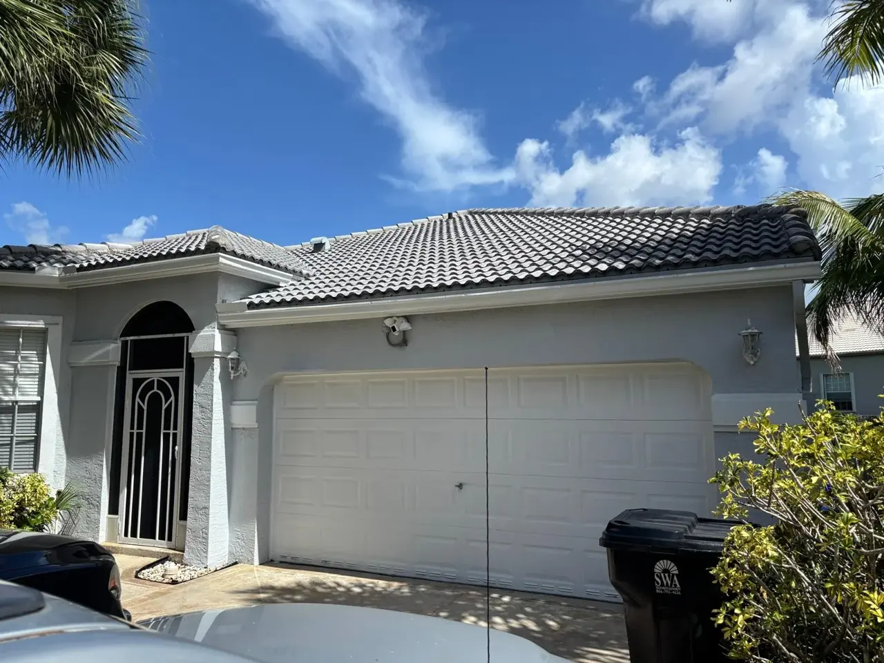 Tile-roof South Florida home with a repainted garage elevation