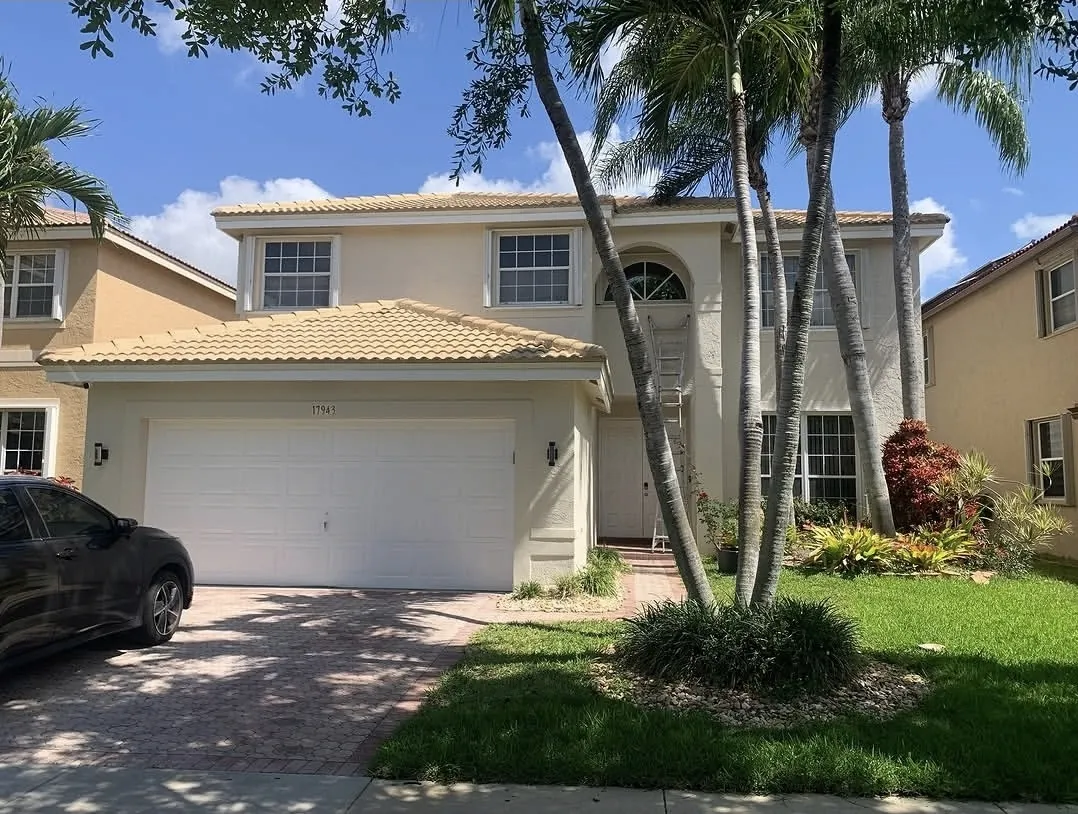 Two-story home exterior after repainting in Plantation, FL