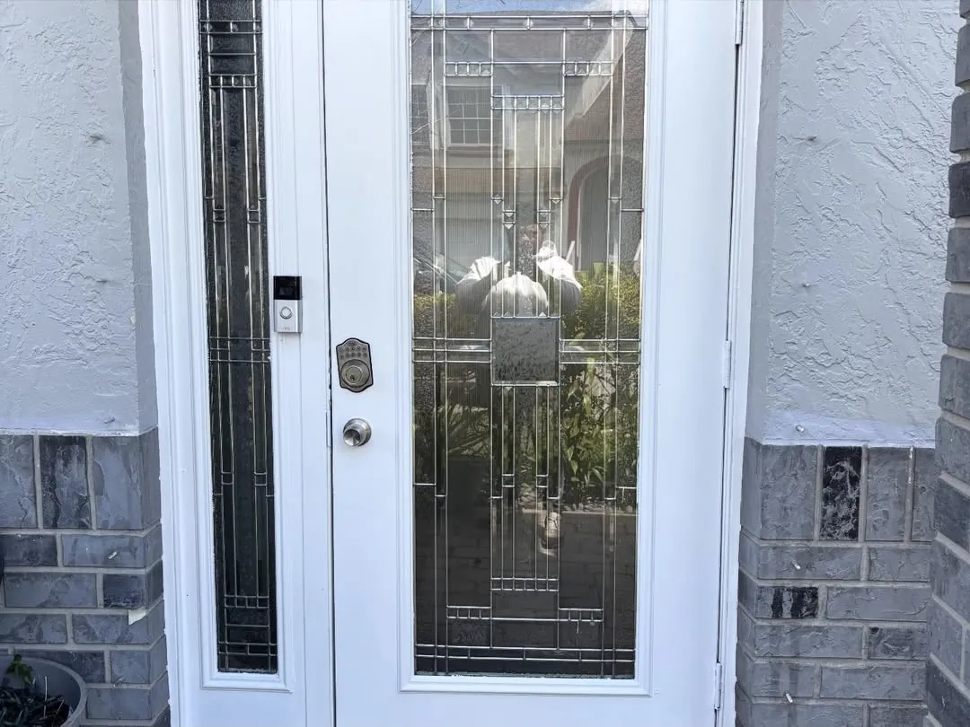 Freshly painted white front door and trim on a South Florida home