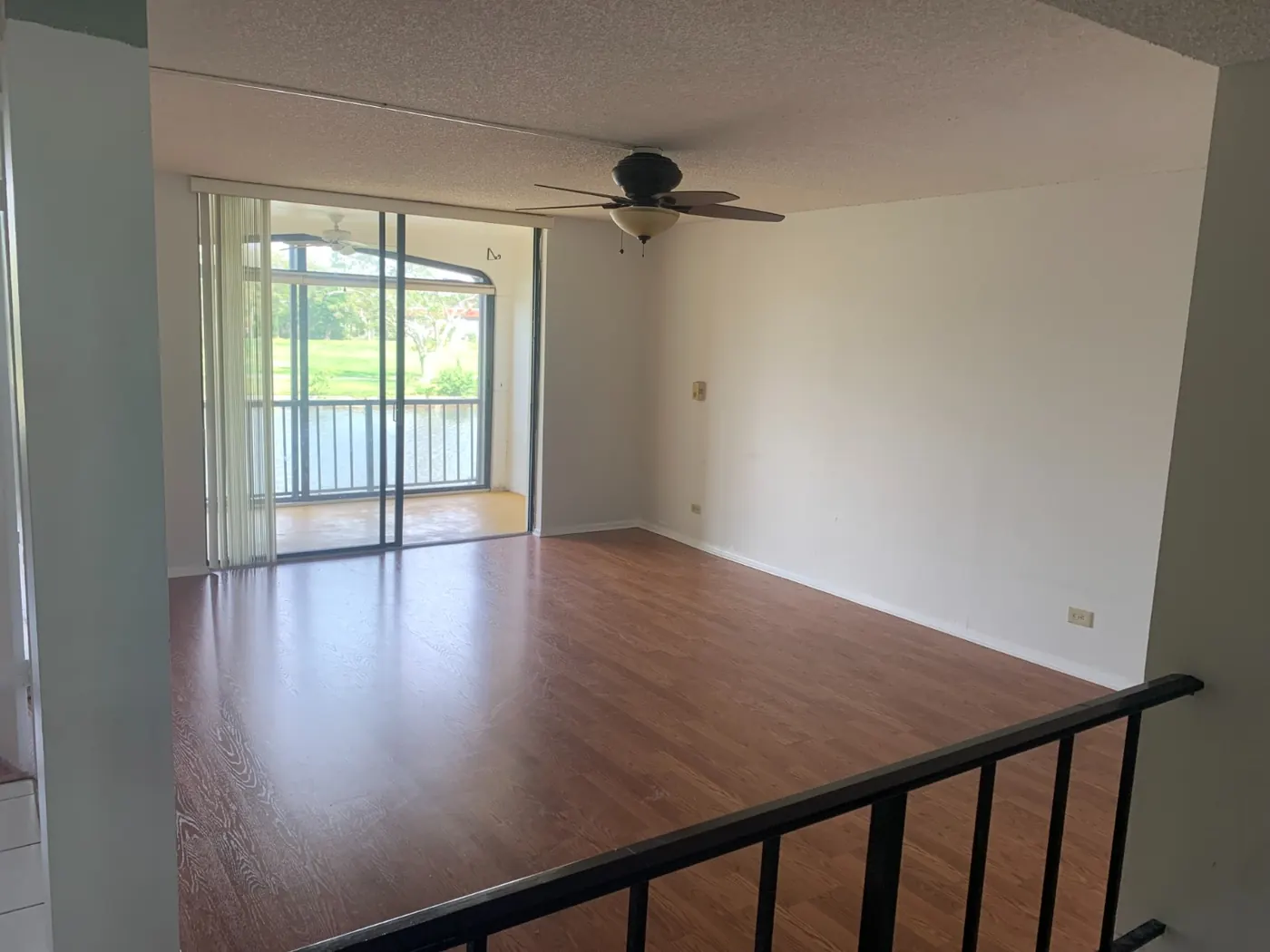 The same condo living room after interior painting in clean white by All County Painters