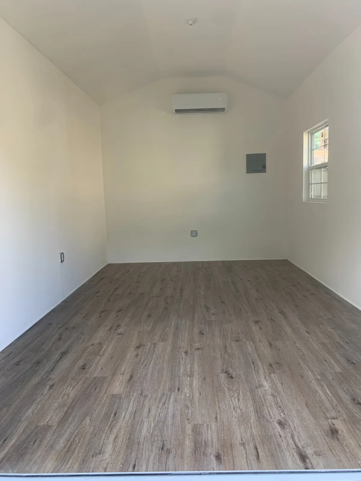 Finished room with painted walls, vinyl plank floor and mini-split