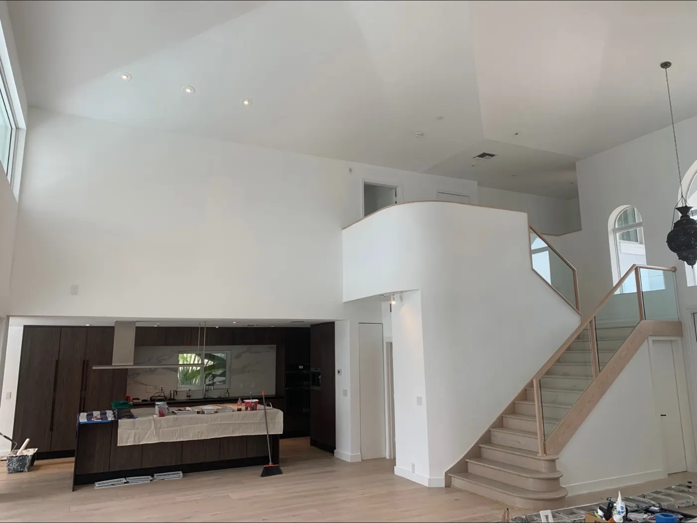 Modern great room painted white with high ceilings by All County Painters