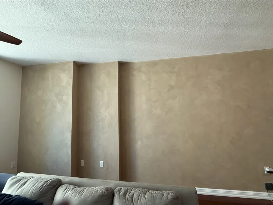 Tan limewash accent wall with soft mineral movement