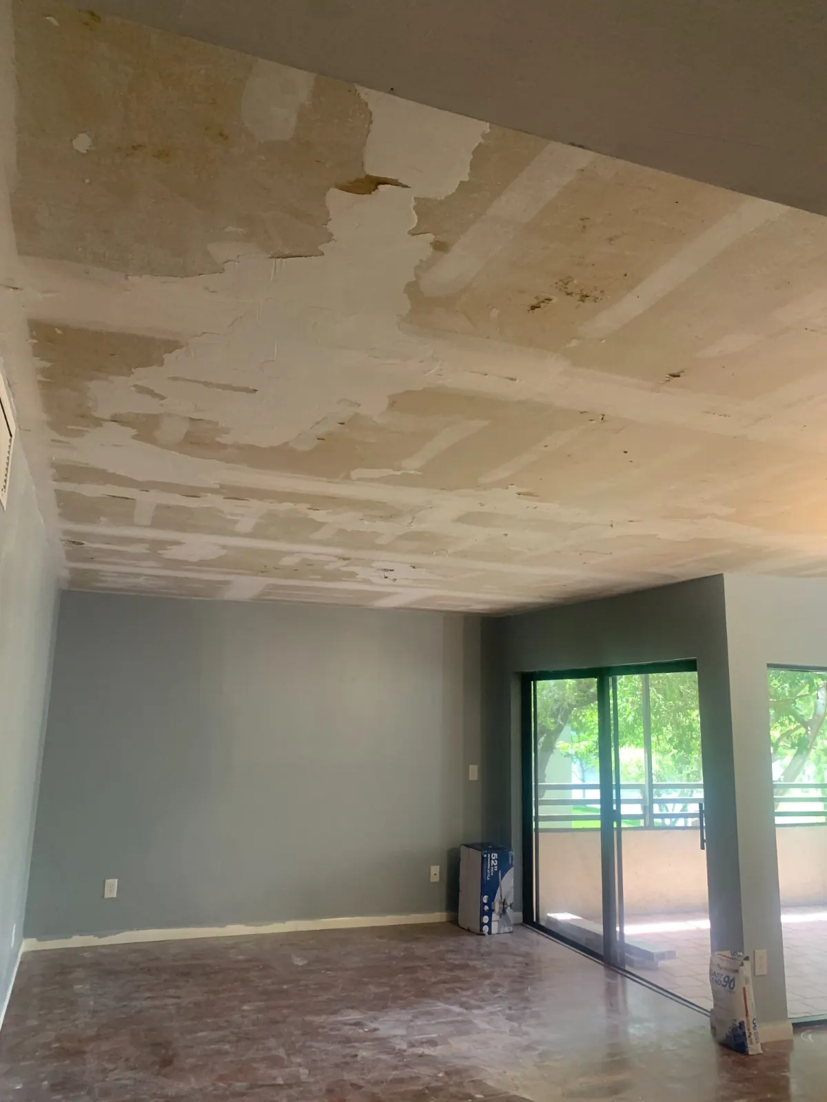 Condo ceiling after popcorn texture removal, prepped for a smooth finish