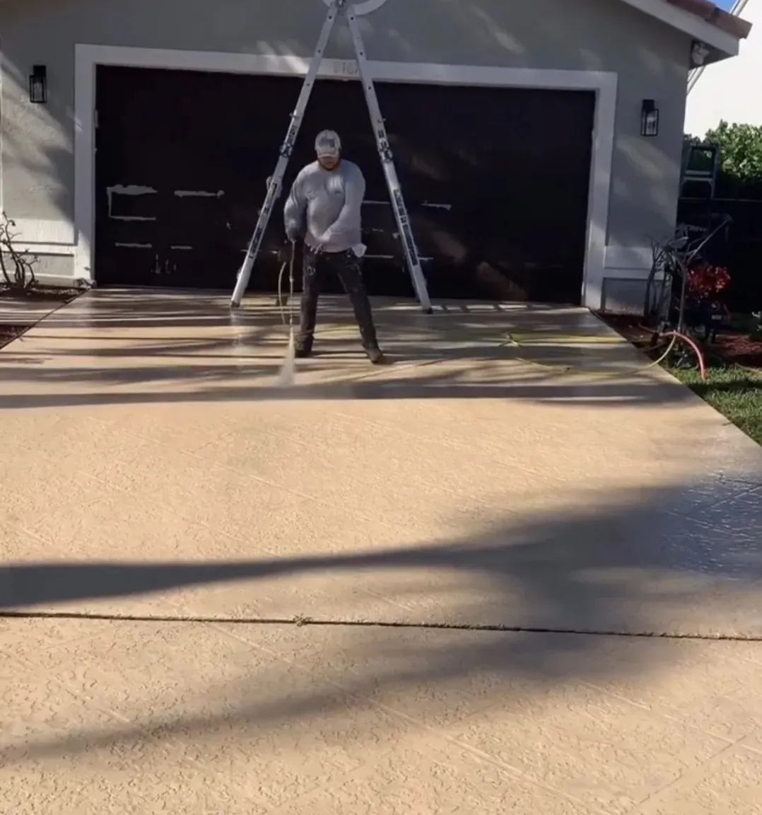 Pressure washing a stamped concrete driveway