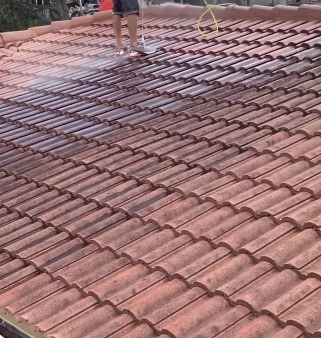 Barrel tile roof half cleaned during pressure washing