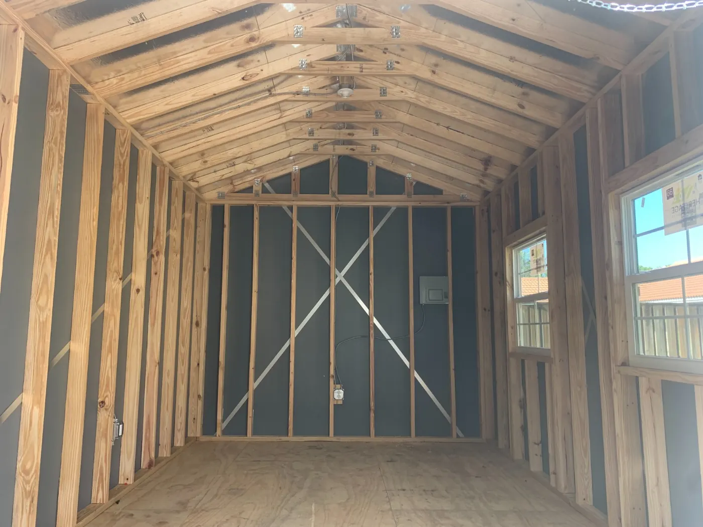 Interior of an outbuilding at bare framing before drywall
